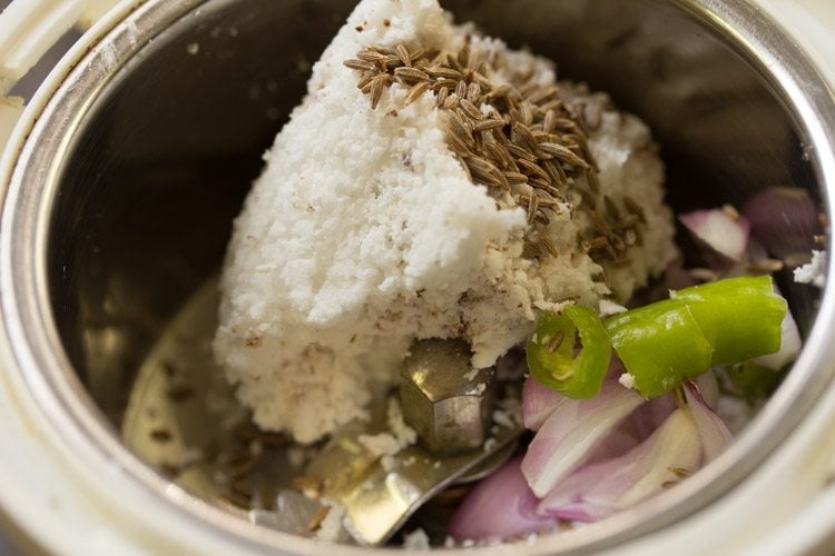 fresh grated coconut, chopped green chili, chopped pearl onion and cumin seeds added to a grinder jar. 