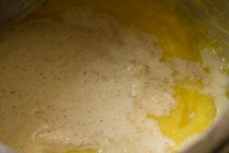 prepared coconut paste added to the cooked, mashed moong dal in the pressure cooker. 