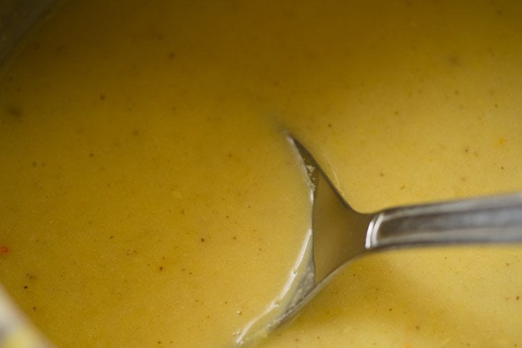 coconut paste, water and salt mixed well with the mashed moong dal in the cooker. 