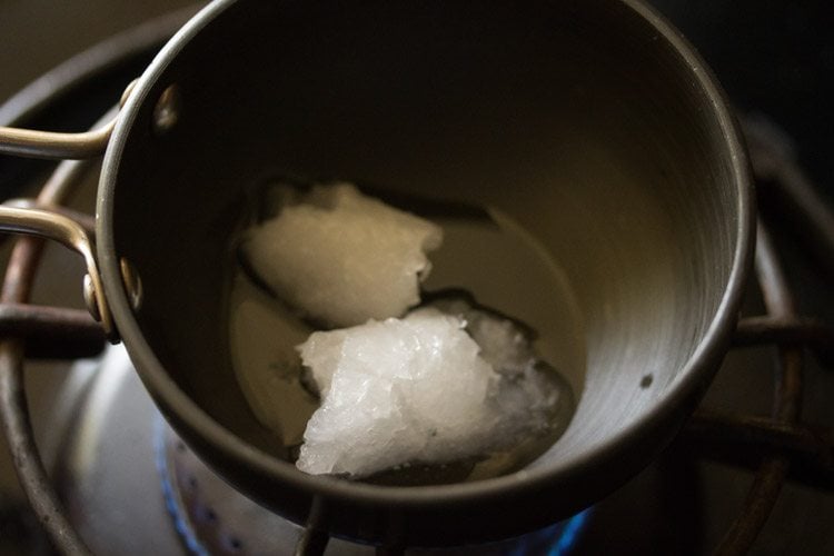 heating coconut oil in a small pan. 