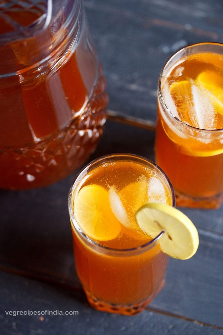 lemon ice tea in glasses with ice cubes and lemon rings.