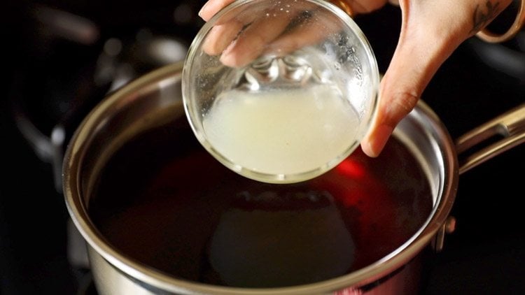 adding lemon juice to the black tea.