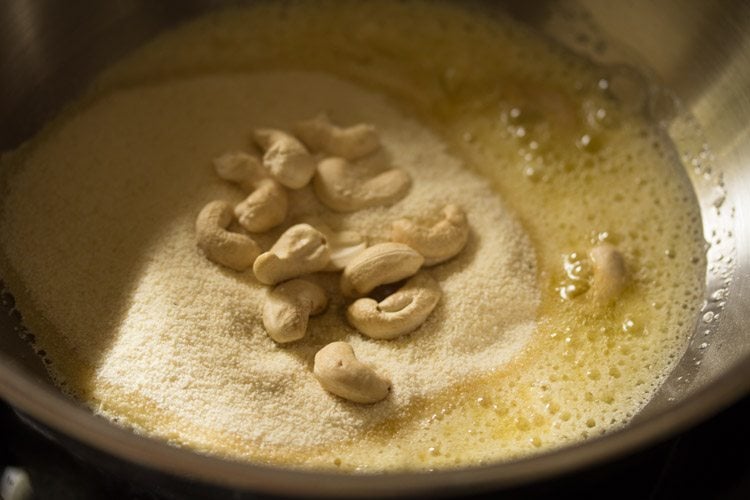 cashewnuts added to the rava in the pan. 