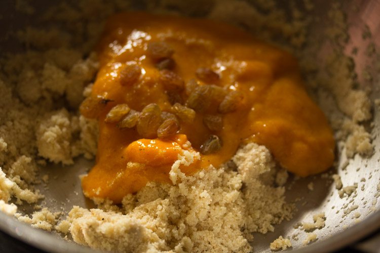 adding prepared mango puree to the roasted rava. 