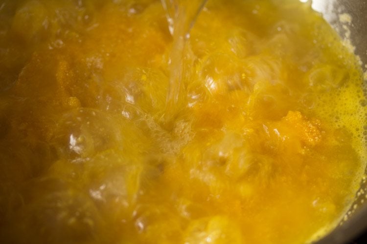 adding boiling water to the mango-rava mixture. 