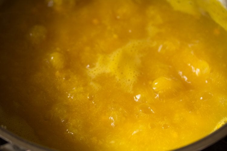 cooking the mango-rava mixture in the pan. 