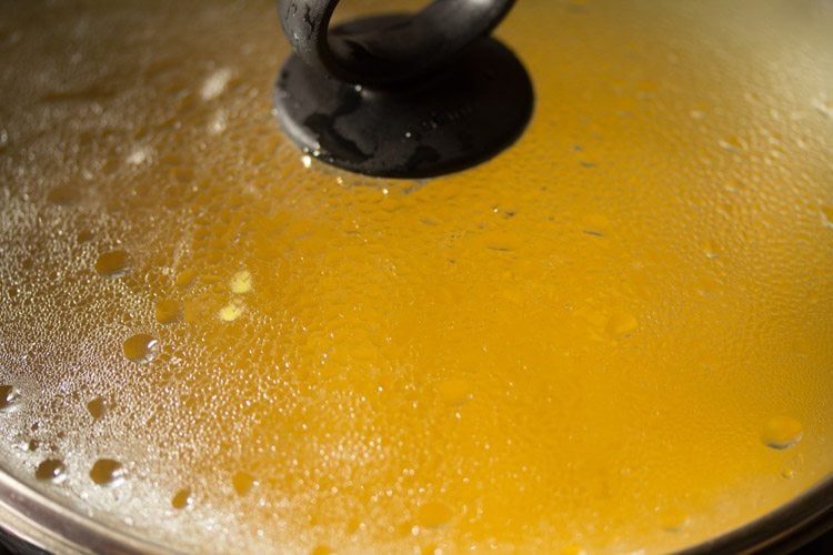 cooking mango kesari in a covered pan. 