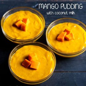 3 bowls of mango pudding on a dark blue table