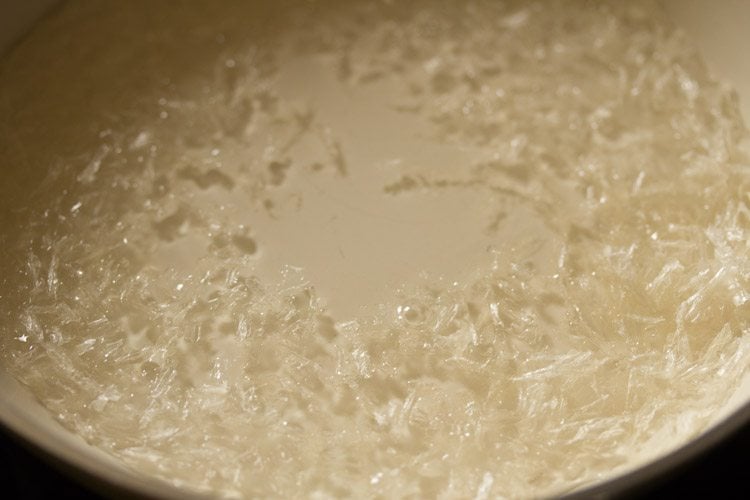 cooking agar agar strands for mango pudding; right now the strands are still visible.