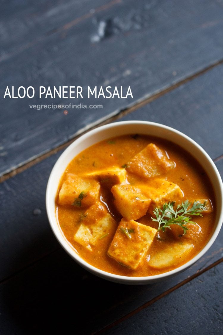 aloo paneer served in a bowl, garnished with coriander sprig