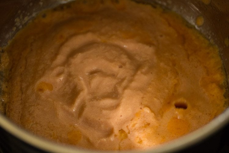 adding ground onion-tomato-cashewnut paste in pan