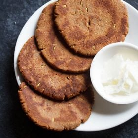 gur ki roti served on white plate with a bowl of white butter and text layover.