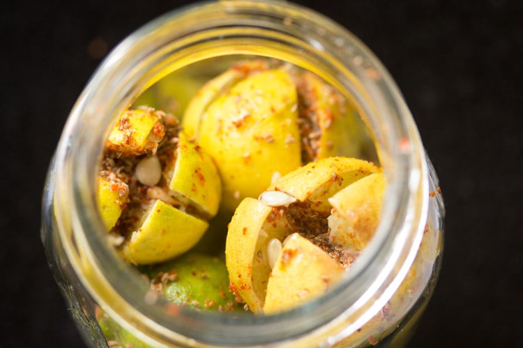 stuffed lemon with the spice mixture in a glass jar