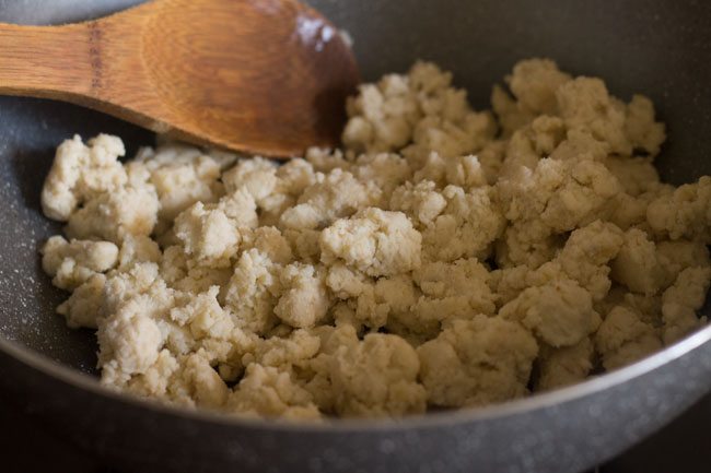 stirring the crumbled khoya in the pan. 