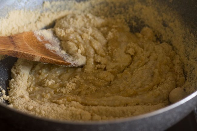stirring the khoya-sugar mixture in the pan. 