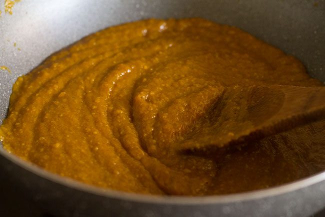 cooking the mango mixture in the pan. 