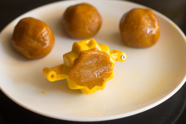 press the small modak mixture ball into the greased modak mould. 