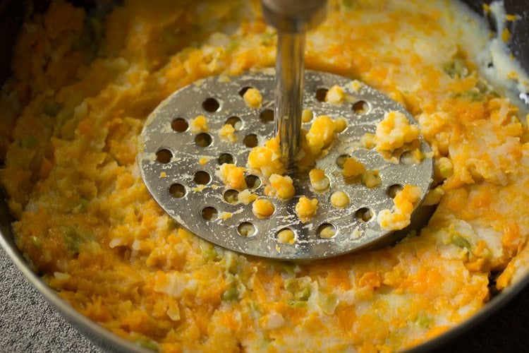 mashing boiled veggies 