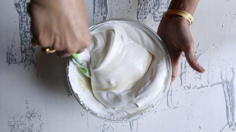 folding together the whipped cream and condensed milk for making my easy no churn ice cream recipe