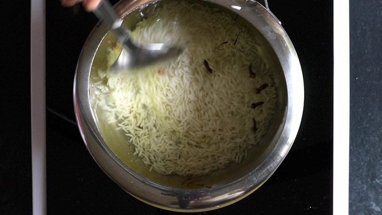 stirring rice in the pressure cooker.