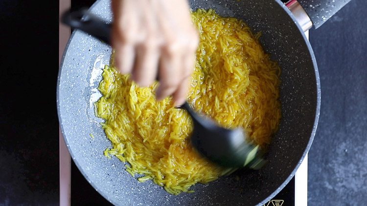 stirring the meethe chawal.