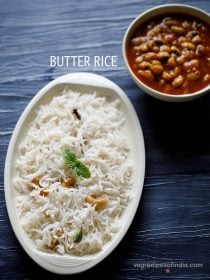 butter rice served in an oval white platter with a garnish of mint sprig on a dark blue board with text layovers.