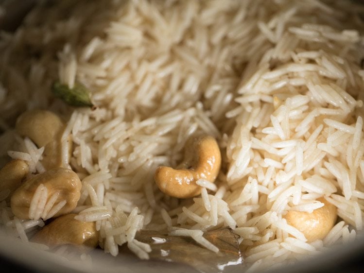 rice mixed with spices and cashews. 