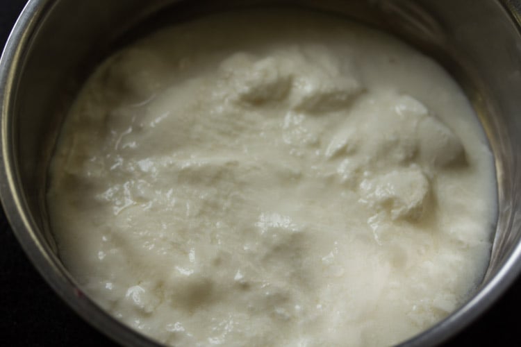 sour curd added to a bowl. 