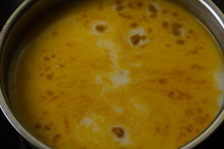 turmeric powder and salt added to buttermilk mixture to make majjiga charu.
