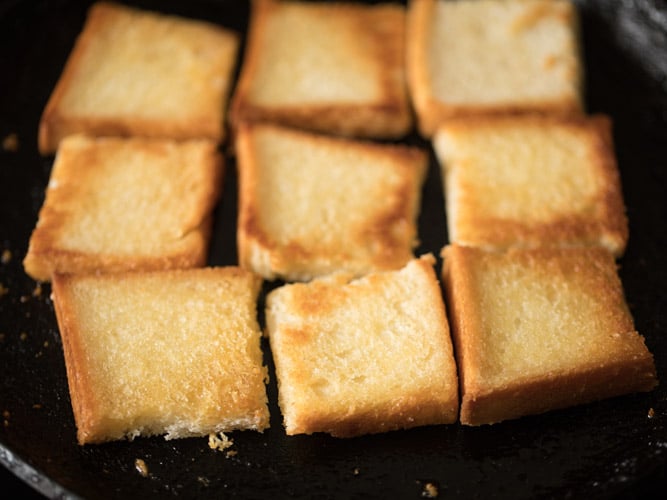 toasting bread pieces till golden for making double ka meetha recipe. 