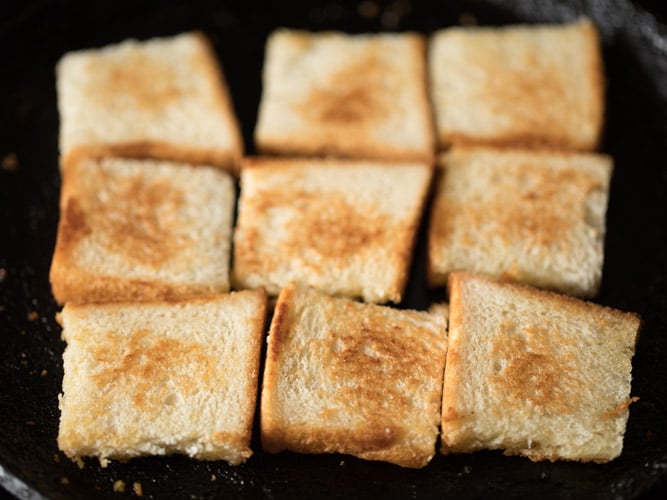 toasting bread pieces till golden for making double ka meetha recipe. 