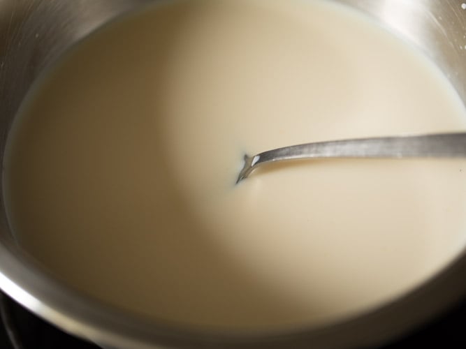 mixing milk with the condensed milk. 