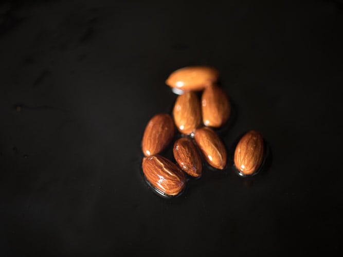 pan frying almonds in hot ghee. 