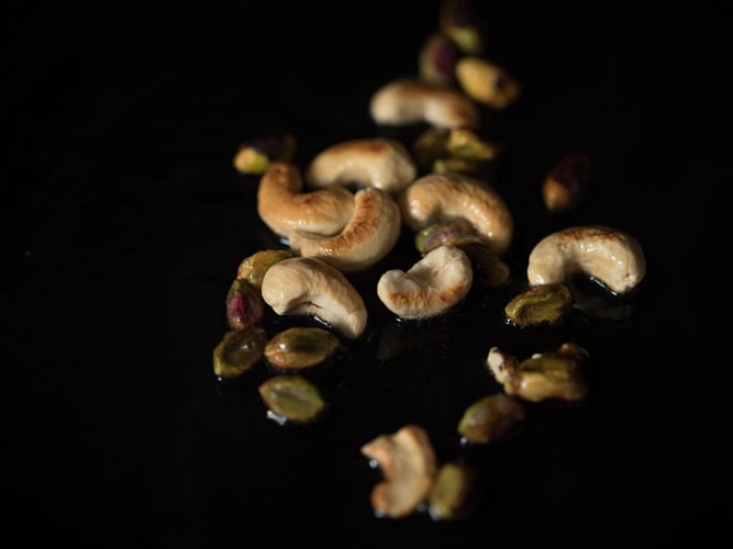 pan frying cashews and pistachios in hot ghee. 