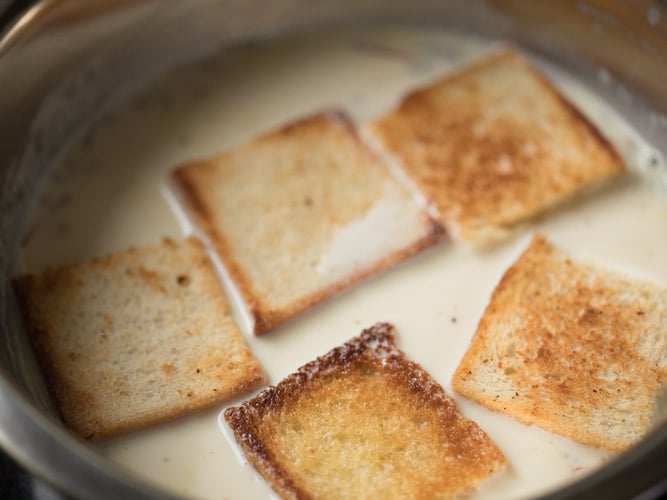 toasted bread pieces arranged on the milk mixture. 