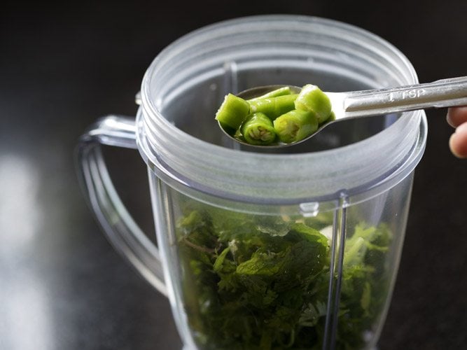 adding chopped green chili in blender jar. 