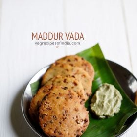 Mat vada on a banana leaf served on a serving plate with coconut chutney and text layover.