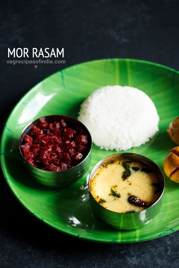 majjige saaru or majjiga charu served in a bowl placed on a green plate with steamed rice and beetroot poriyal and text layover. 