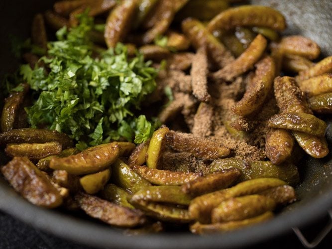 garam masala powder, dried mango powder and chopped coriander leaves added to the pan. 