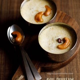 aval payasam garnished with fried cashews and raisins and served in 2 bowls with a fried cashew kept on a spoon on the left side and text layovers.