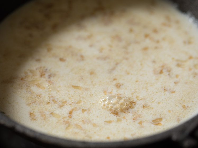 Add milk to roasted poha to make poha kheer. 