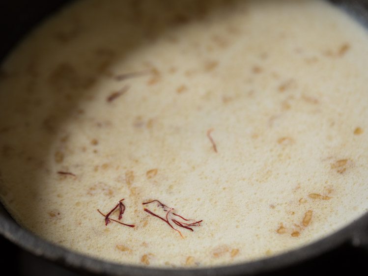 saffron strands added to poha-milk mixture. 