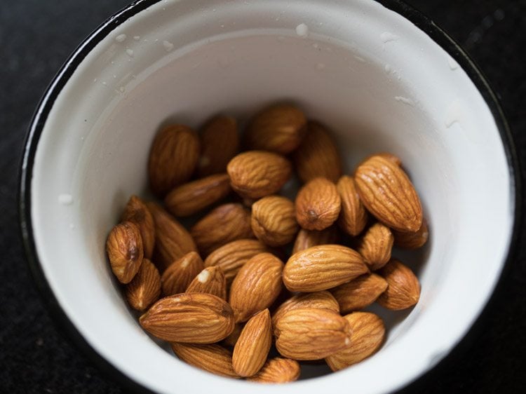 rinsed almonds in a bowl to make badam milk recipe.