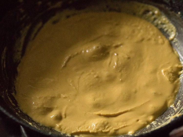 besan mixture melting and releasing ghee from the sides. 