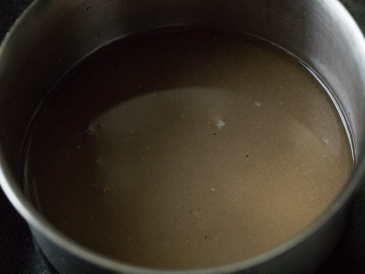 sugar and water added to another pan for making sugar syrup for besan barfi recipe. 