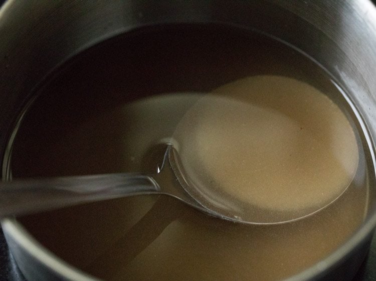 stirring with a spoon to dissolve the sugar. 