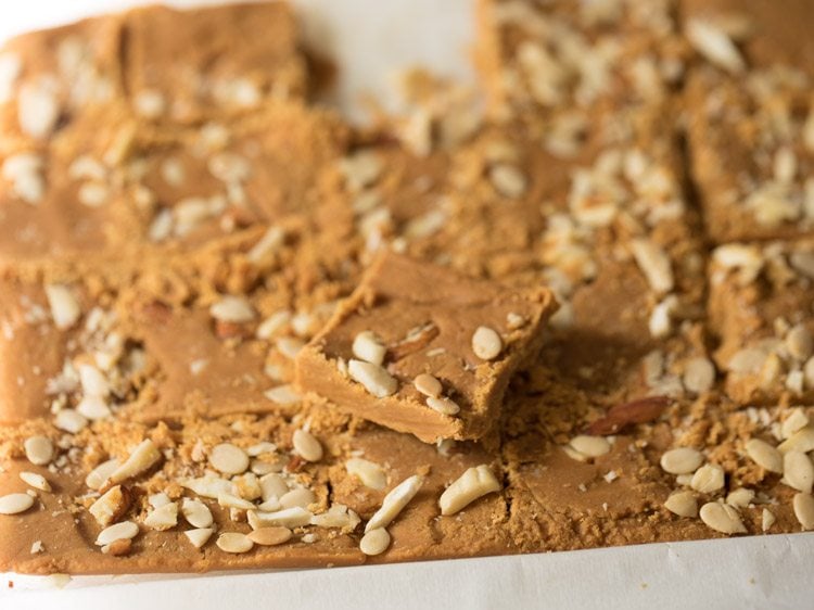 slicing set barfi mixture into pieces. 