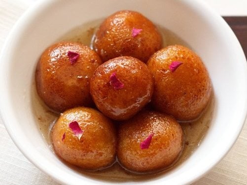gulab jamun in a white bowl.