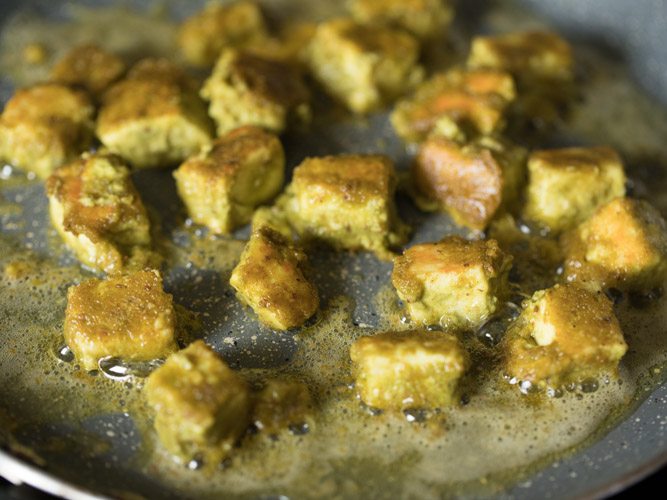 frying paneer cubes till golden and crisp on both sides. 