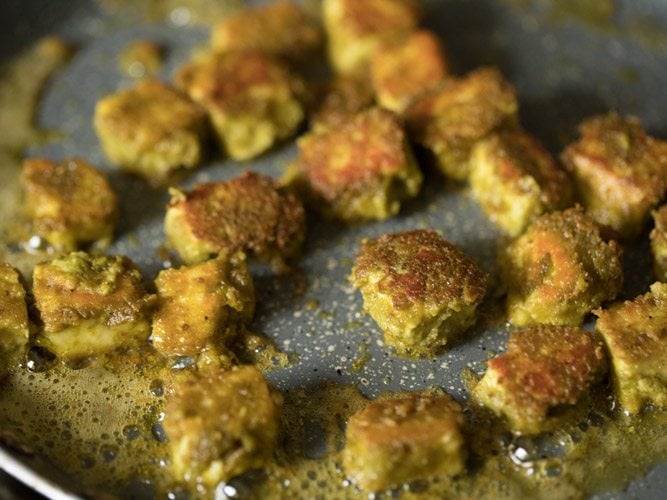 frying paneer cubes till golden and crisp on both sides. 